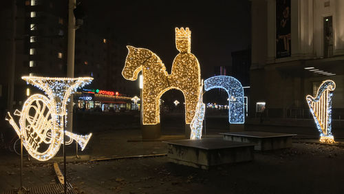 Illuminated christmas lights on building at night