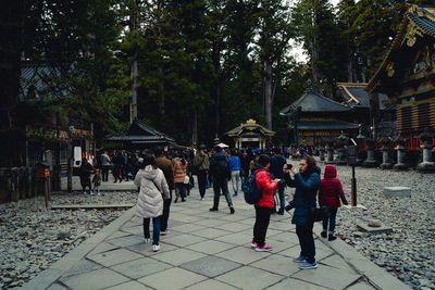 Group of people walking on footpath