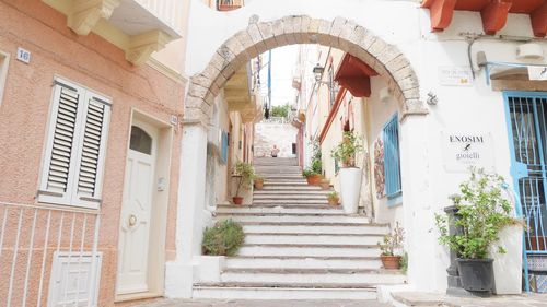 Low angle view of staircase amidst buildings