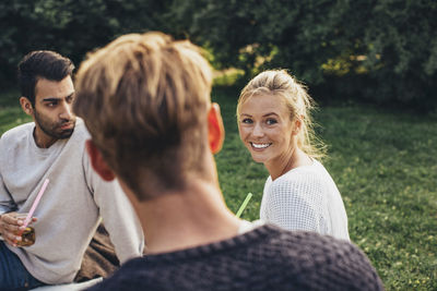 Portrait of friends sitting outdoors