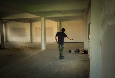 Rear view of men standing at home