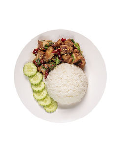 Close-up of food in plate against white background