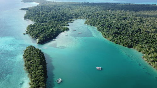 High angle view of sea by trees against sky