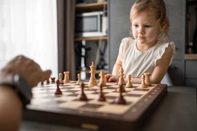 Boy playing chess at home