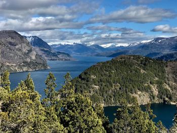 Scenic view of sea and mountains against sky
