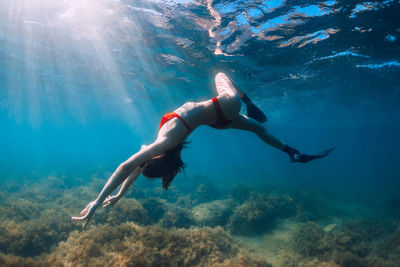 Side view of man swimming in sea