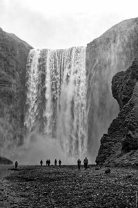 People against waterfall