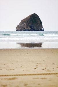 Scenic view of beach against clear sky