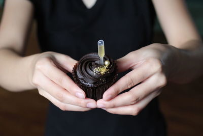 Close-up of woman holding cake