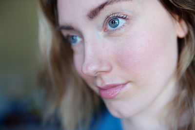 Close-up of young woman with blue eyes