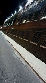 Low angle view of illuminated railroad station at night