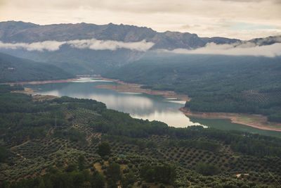 Scenic view of lake and mountains against sky