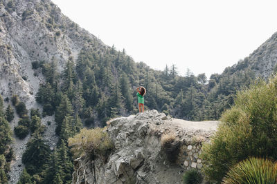 Low angle view of woman standing on mountain