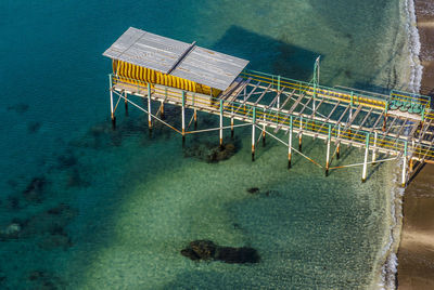 High angle view of old pier at beach