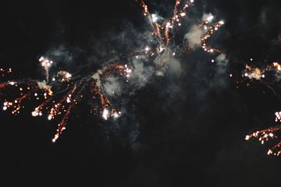 Low angle view of firework display at night