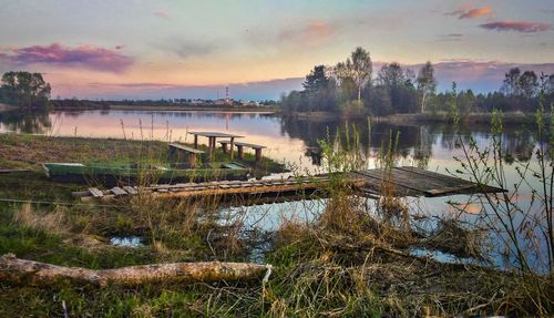 Scenic view of lake against sky at sunset