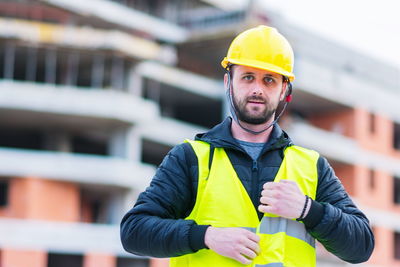 Portrait of construction worker against built structure 