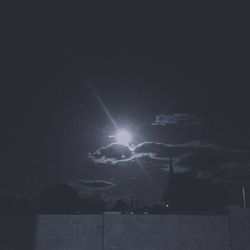 Low angle view of illuminated street light against sky
