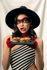 Portrait of young woman holding ice cream