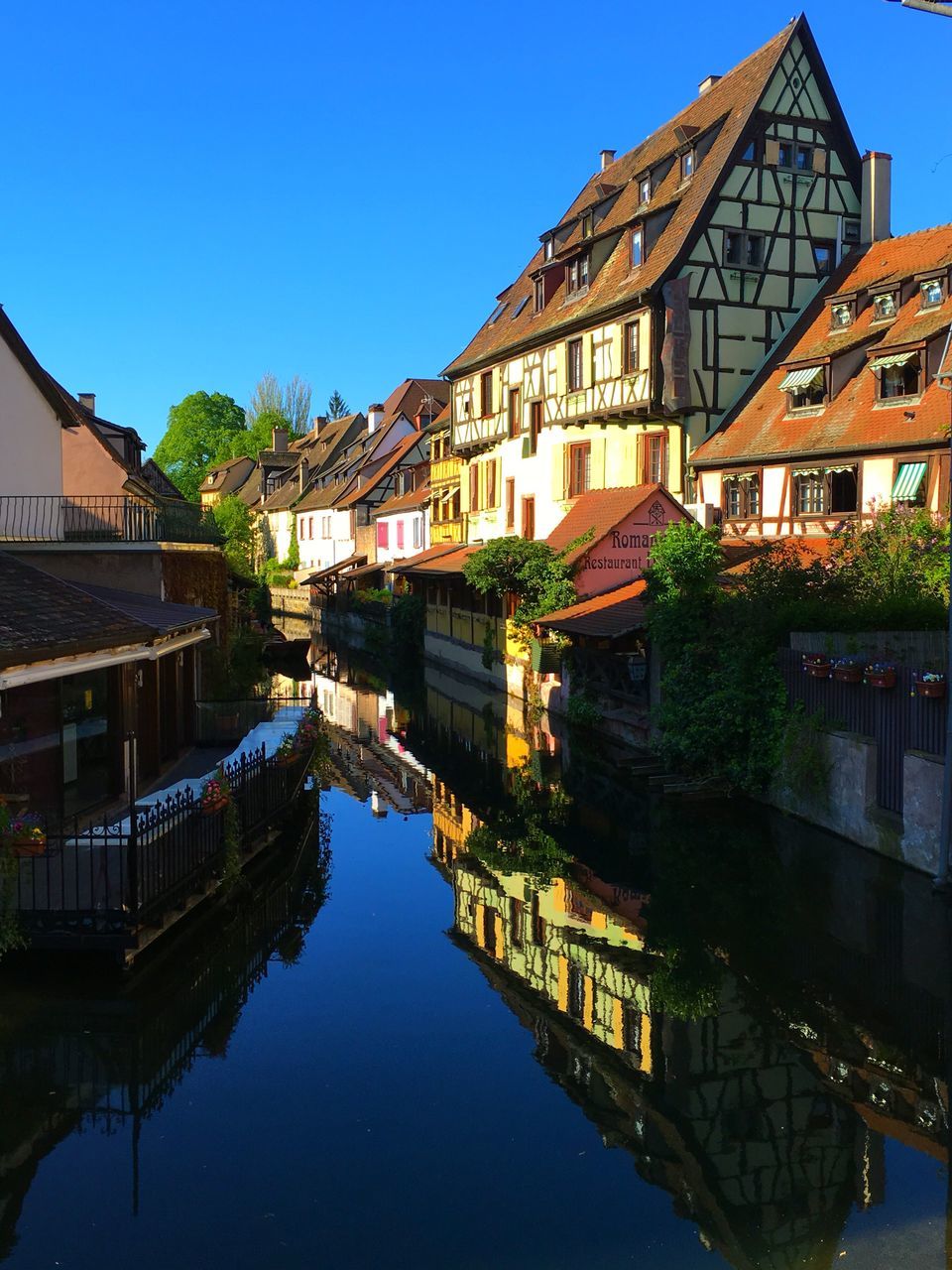 architecture, built structure, building exterior, water, clear sky, reflection, canal, waterfront, river, blue, residential structure, residential building, connection, house, city, building, bridge - man made structure, outdoors, day, bridge