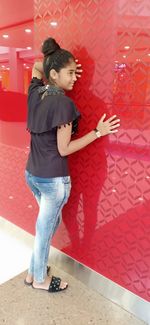 High angle view of woman looking down while standing on tiled floor