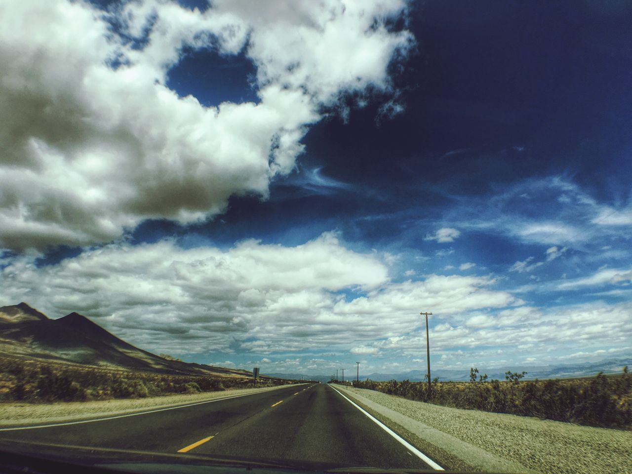 sky, road, the way forward, transportation, cloud - sky, cloudy, diminishing perspective, landscape, cloud, road marking, vanishing point, country road, highway, tranquil scene, tranquility, nature, scenics, blue, empty road, mountain