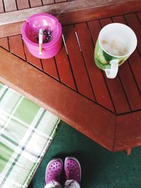 Low section of person with drink on table