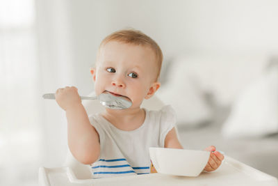 Portrait of cute baby girl sitting