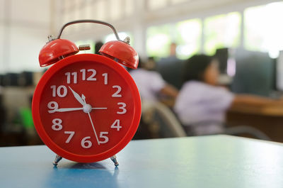 Close-up of clock on table at home