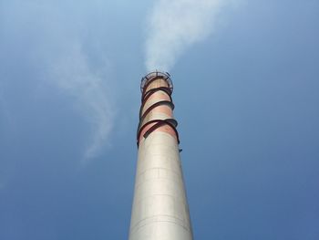 Low angle view of smoke stack against sky