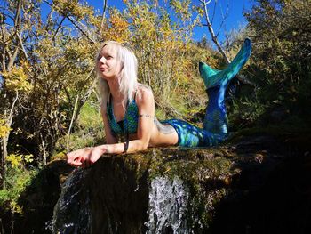 A mermaid caught in a creek cooling her fins