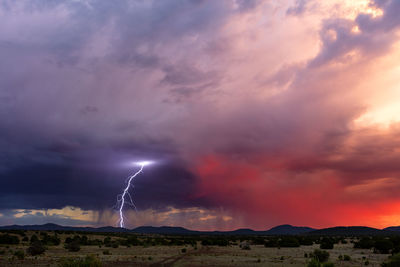 Lightning strikes from a monsoon thunderstorm at sunset near show low, arizona.