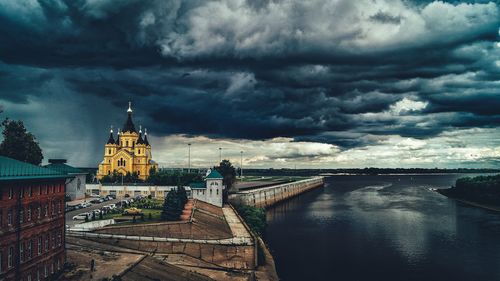 Buildings against cloudy sky