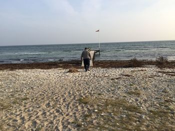 Man on beach against sky