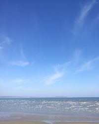 Scenic view of sea against blue sky