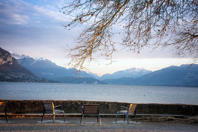 Scenic view of lake by snowcapped mountains against sky