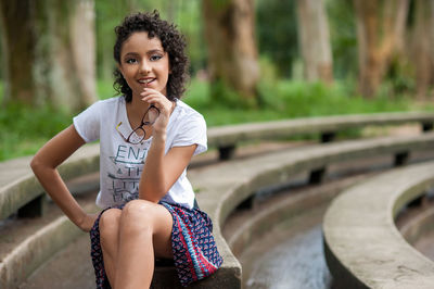 Portrait of smiling girl sitting outdoors