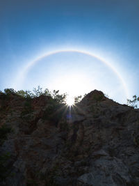 Rainbow over mountain against sky