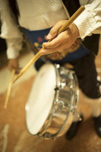 Low section of man playing piano