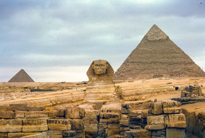 The sphinx and pyramid of chephren against cloudy sky