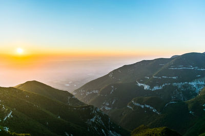 Scenic view of mountains against sky during sunset