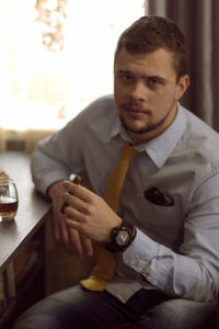Portrait of man sitting at home