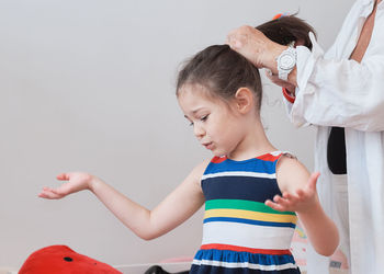 Pretty girl trying on summer outfits with grandmother