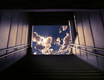 Low angle view of staircase by building against sky