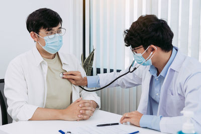 Female doctor examining patient at clinic