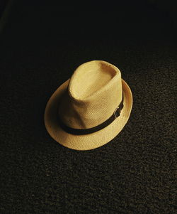 Close-up of hat on black background