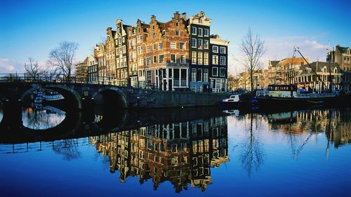 Boats in river with buildings in background