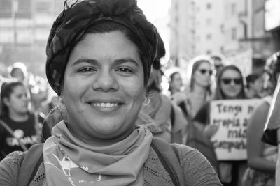 Portrait of smiling young woman in city