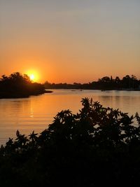 Scenic view of lake against sky during sunset