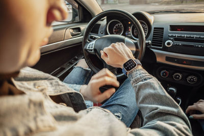 Smart watch on the hand of car driver, close up. transport, business trip, technology time concept